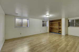 Spare room with light wood finished floors and a textured ceiling