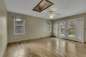 Unfurnished room with french doors, light wood finished floors, and plenty of natural light