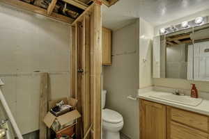 Bathroom with vanity and a textured ceiling