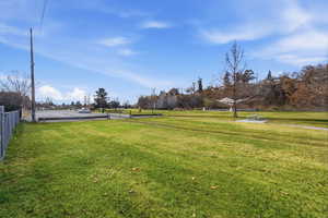 View of property's community featuring a yard