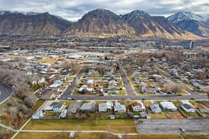 Aerial overview of property's location featuring nearby suburban area and a mountain backdrop