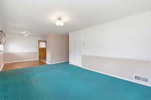 Carpeted spare room with baseboards