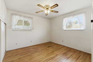 Unfurnished room featuring crown molding, light wood finished floors, and a ceiling fan