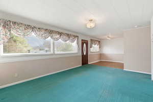 Unfurnished room featuring baseboards and carpet