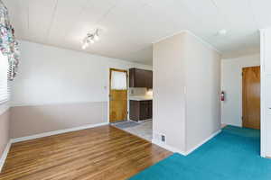 Spare room featuring light wood finished floors and baseboards