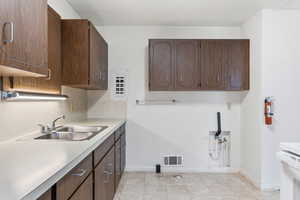 Laundry room featuring cabinet space, washer hookup, and light tile patterned floors