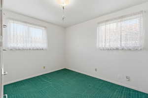 Spare room featuring baseboards and carpet flooring