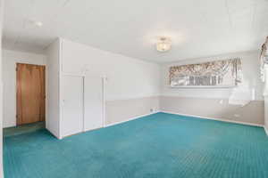 Carpeted empty room with baseboards