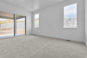 Carpeted empty room featuring baseboards