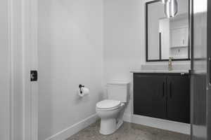 Bathroom with vanity and baseboards