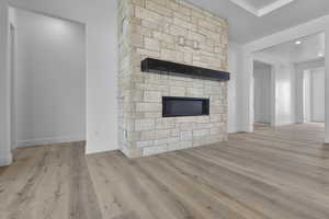 Detailed view of a fireplace and wood finished floors