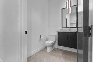 Bathroom featuring vanity and baseboards