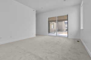Empty room featuring light colored carpet and recessed lighting
