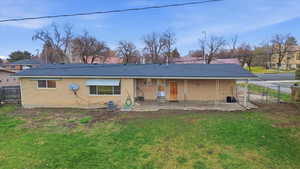 Rear view of property featuring a patio area, brick siding, and a shingled roof