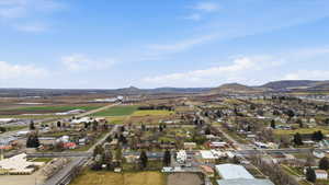 Aerial view of property and surrounding area with mountains