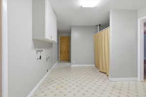 Washroom featuring light floors and cabinet space