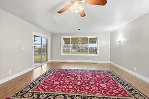 Unfurnished room with plenty of natural light, ceiling fan, and light wood-type flooring