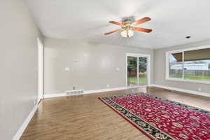 Large living area with access to the covered patio and backyard