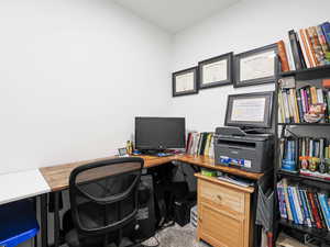 Home office featuring light carpet