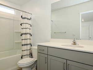 Full bathroom featuring shower / bathtub combination with curtain and vanity