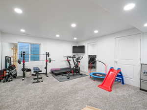 Workout room with carpet flooring and recessed lighting