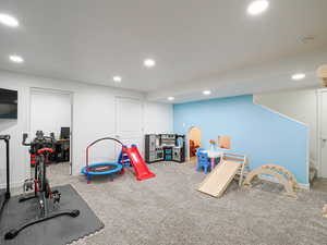 Recreation room featuring carpet flooring and recessed lighting