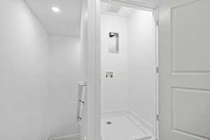 Washroom with washer hookup and recessed lighting