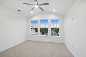 Empty room with light carpet, lofted ceiling, and a ceiling fan