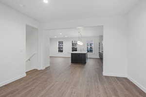 Unfurnished living room with recessed lighting and dark wood-style floors