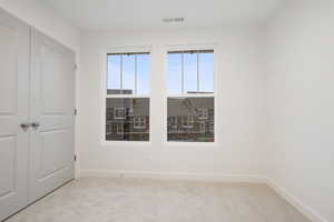 Unfurnished bedroom with a closet and light colored carpet