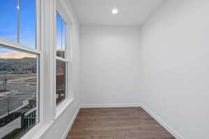 Unfurnished room with dark wood-style flooring and recessed lighting
