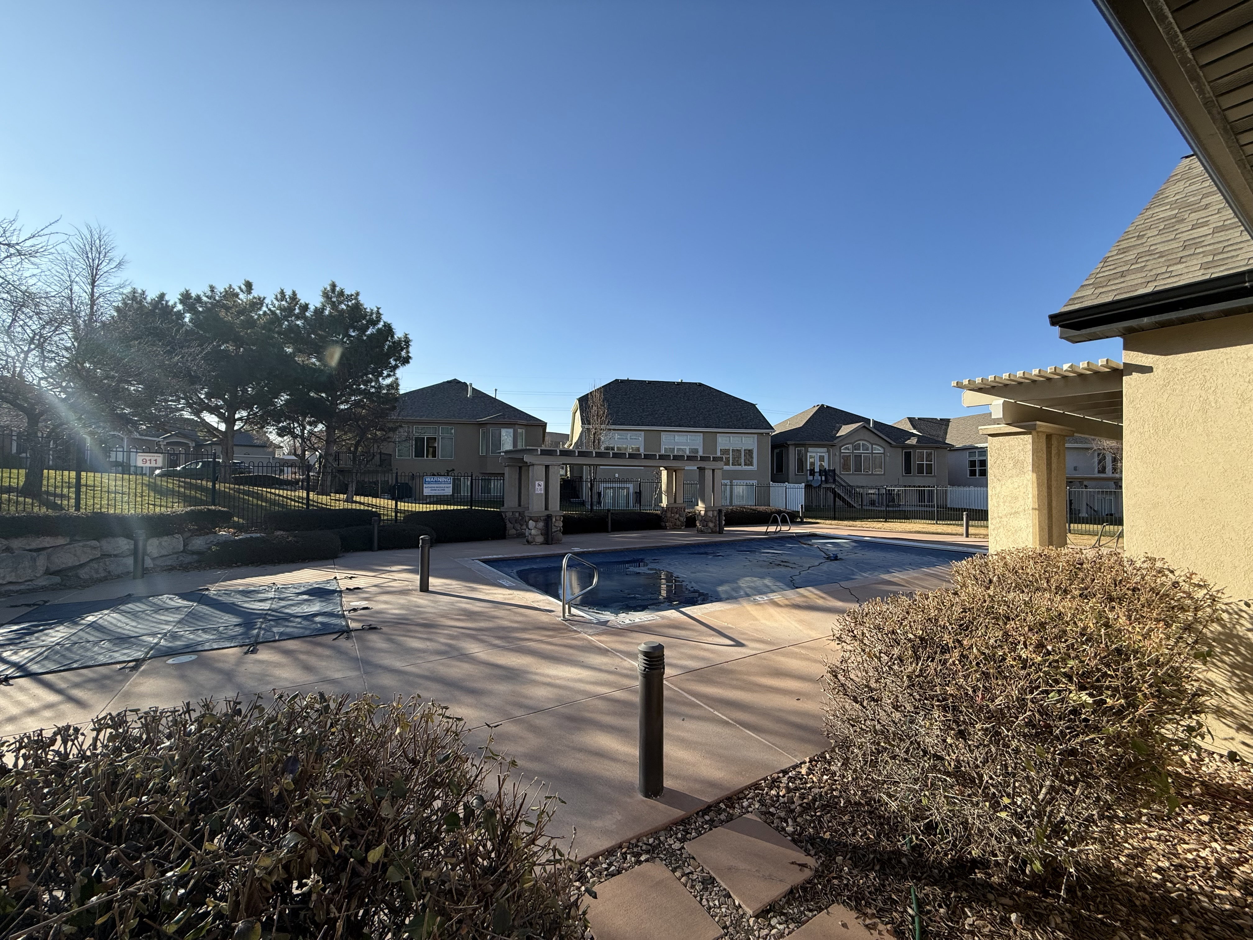 Clubhouse pool featuring a residential view and a patio