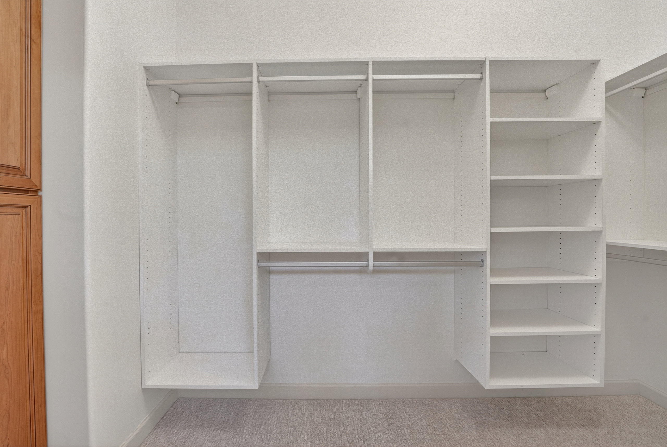 Custom closet system featuring white shelving units