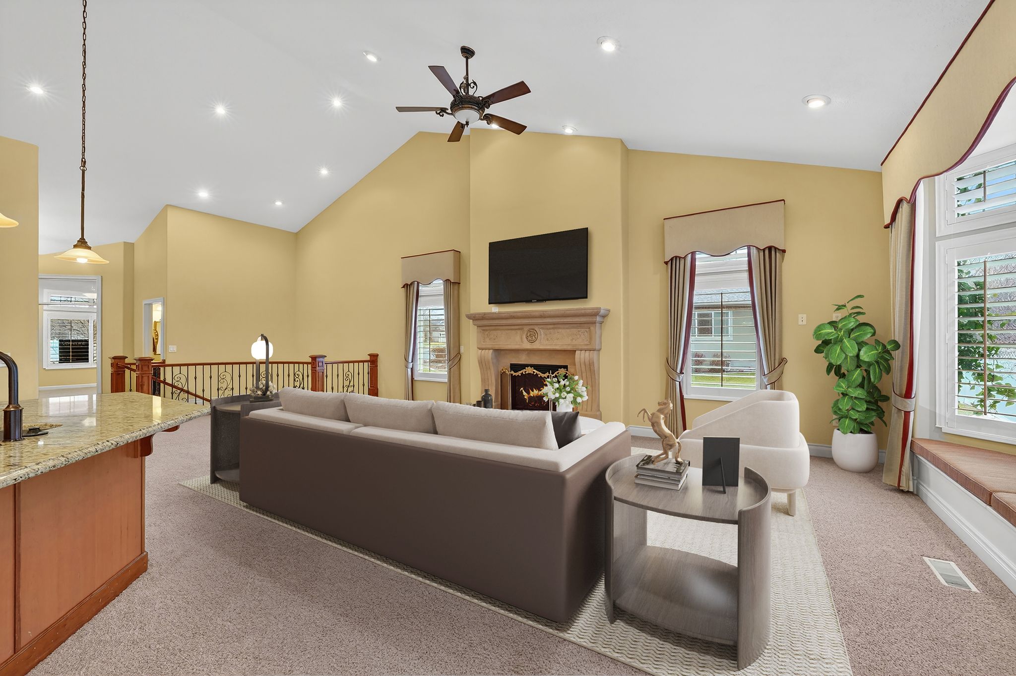 Living area with a lit fireplace, light carpet, ceiling fan, vaulted ceiling, and recessed lighting
