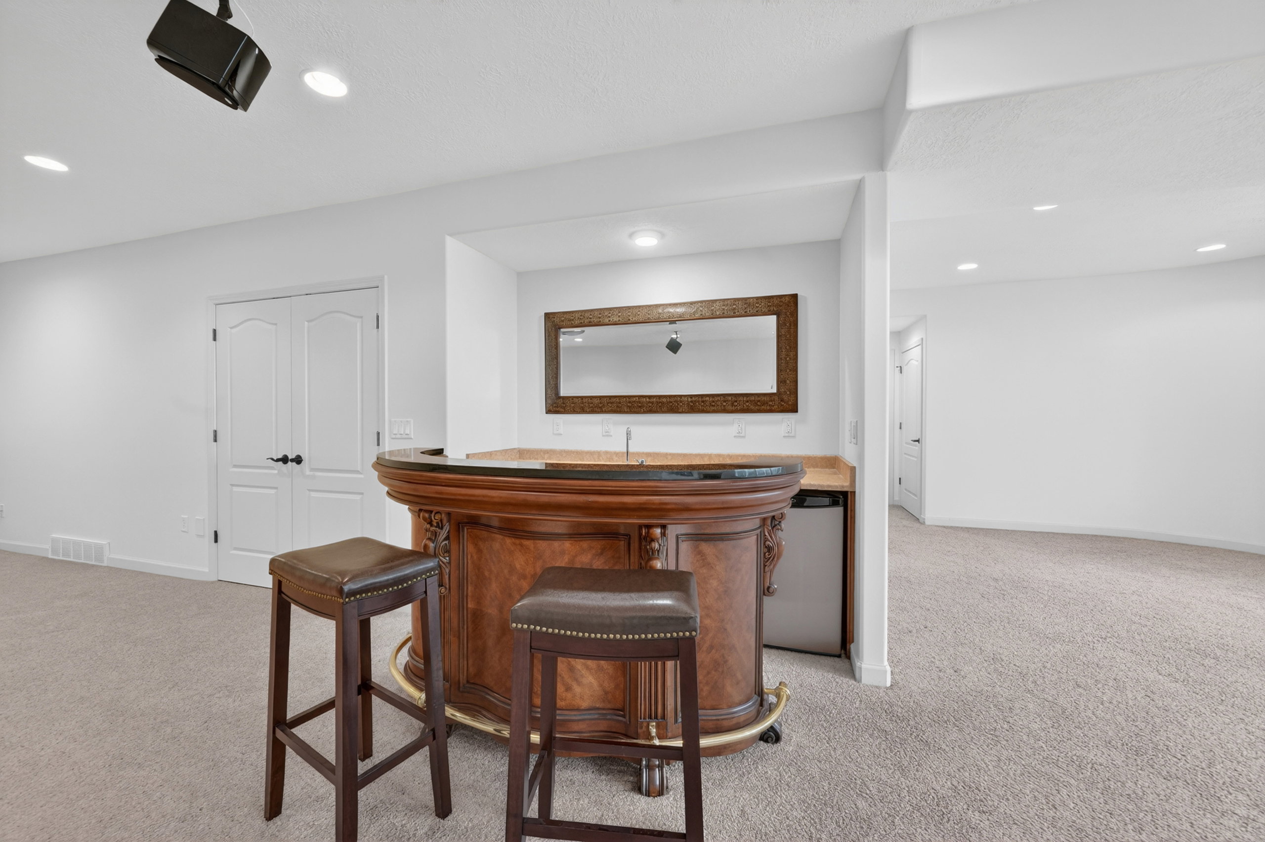 Wet bar featuring a wood-finish bar and a built-in beverage refrigerator