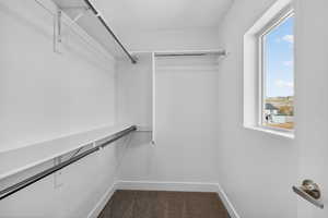 Walk in closet featuring dark carpet