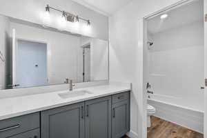 Full bathroom with vanity, light wood-style floors, and bathing tub / shower combination