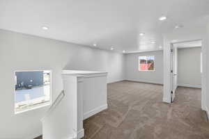 Basement with carpet flooring, recessed lighting, and a textured ceiling