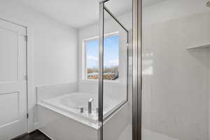 Full bath with a stall shower and a garden tub
