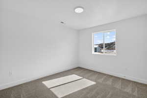 Spare room featuring carpet flooring