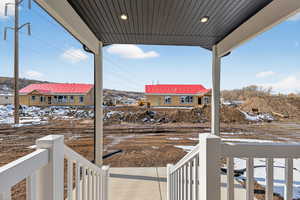 Snowy yard with covered porch