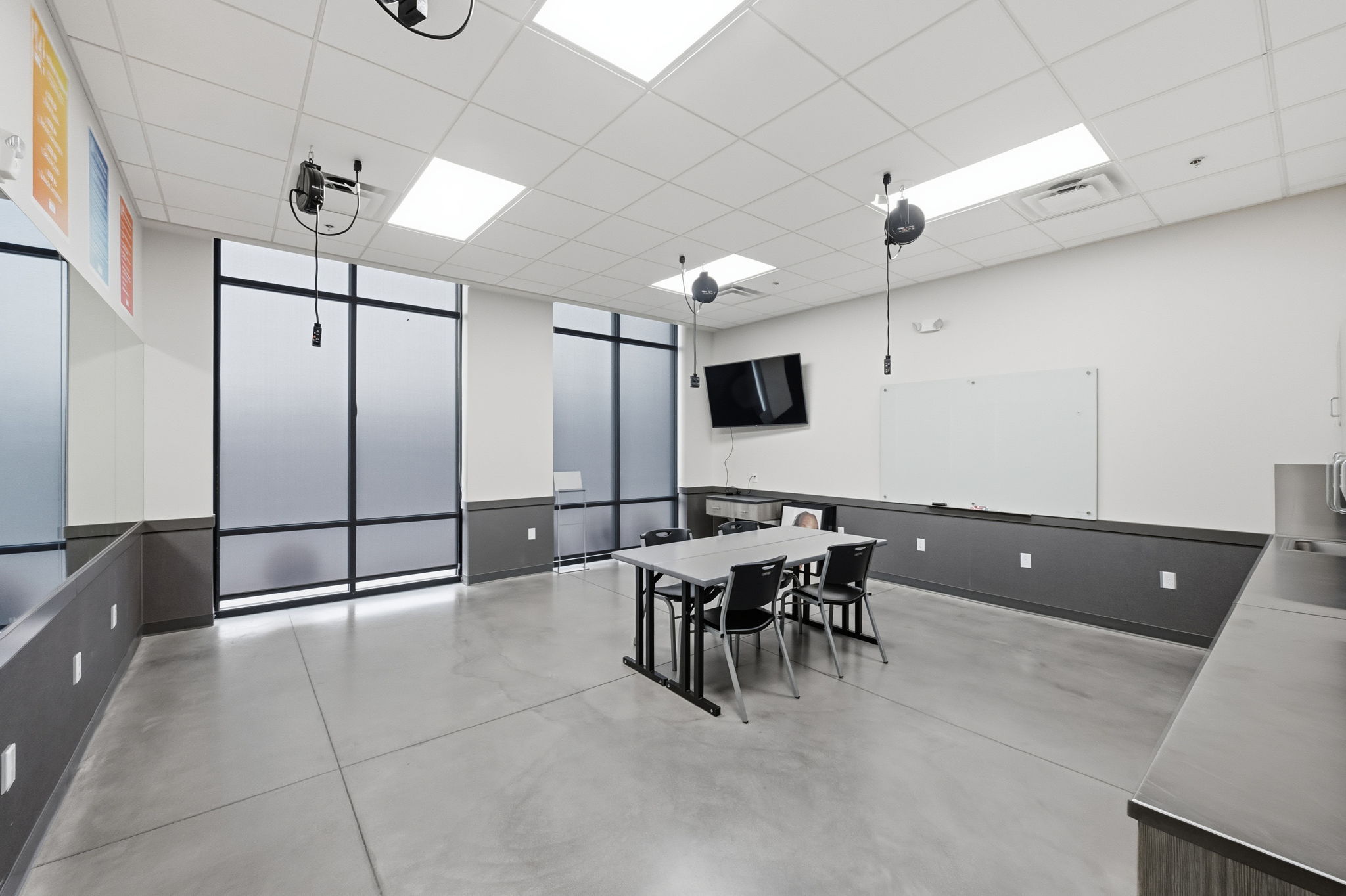 Dining space with a paneled ceiling and concrete floors