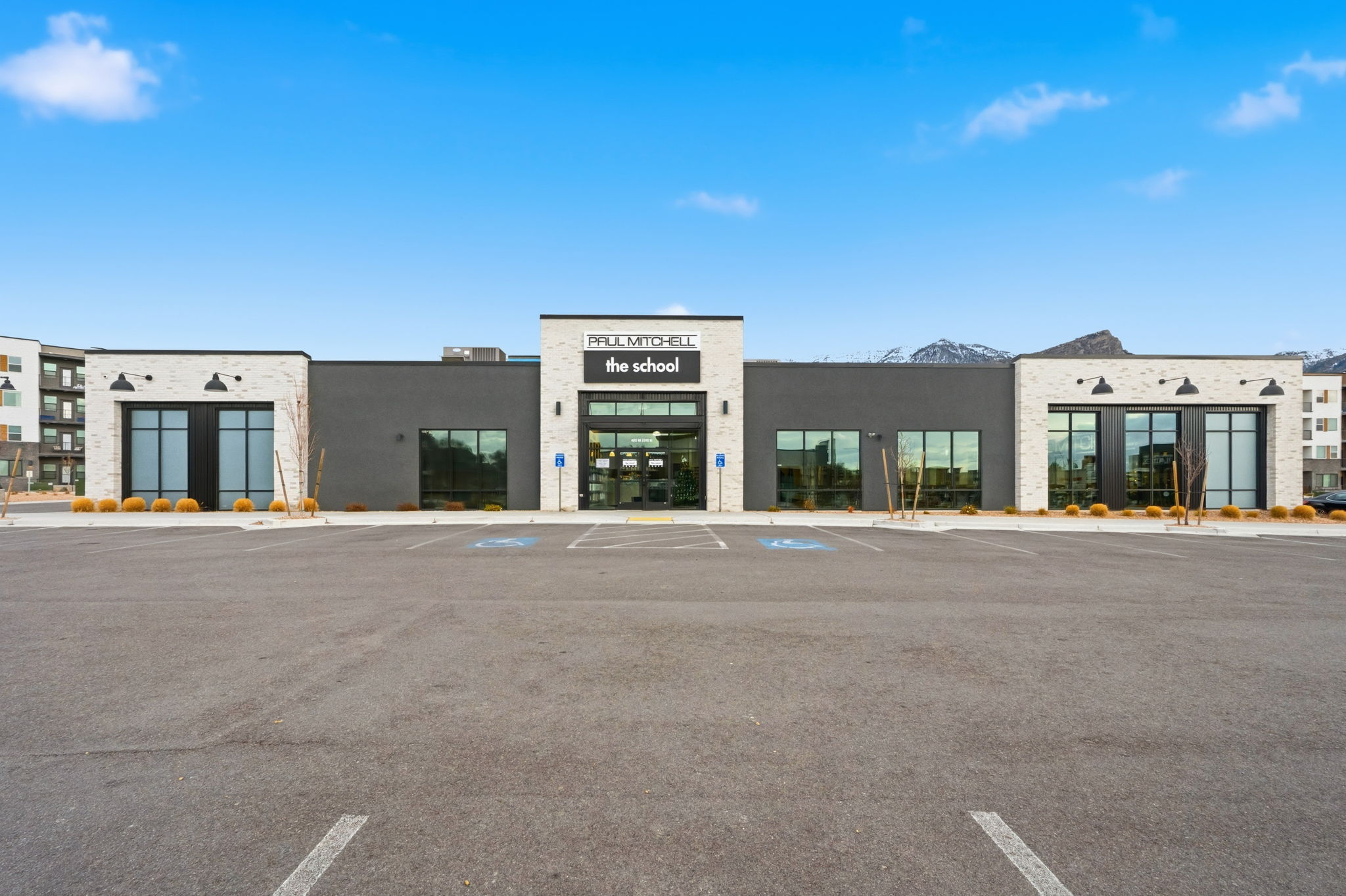 View of commercial property with uncovered parking