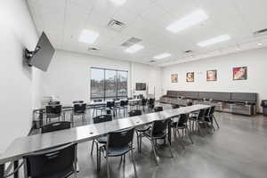 Dining room with finished concrete floors and a drop ceiling
