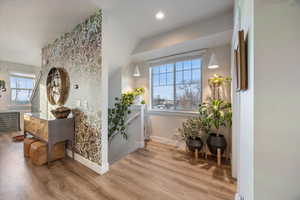 Hall with wood finished floors and plenty of natural light