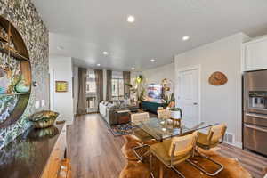 Dining space with light wood-style flooring, recessed lighting, and a textured ceiling