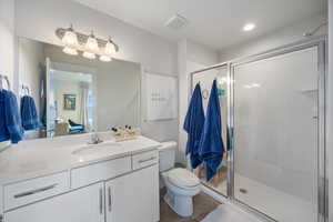Bathroom featuring vanity, a stall shower, and recessed lighting