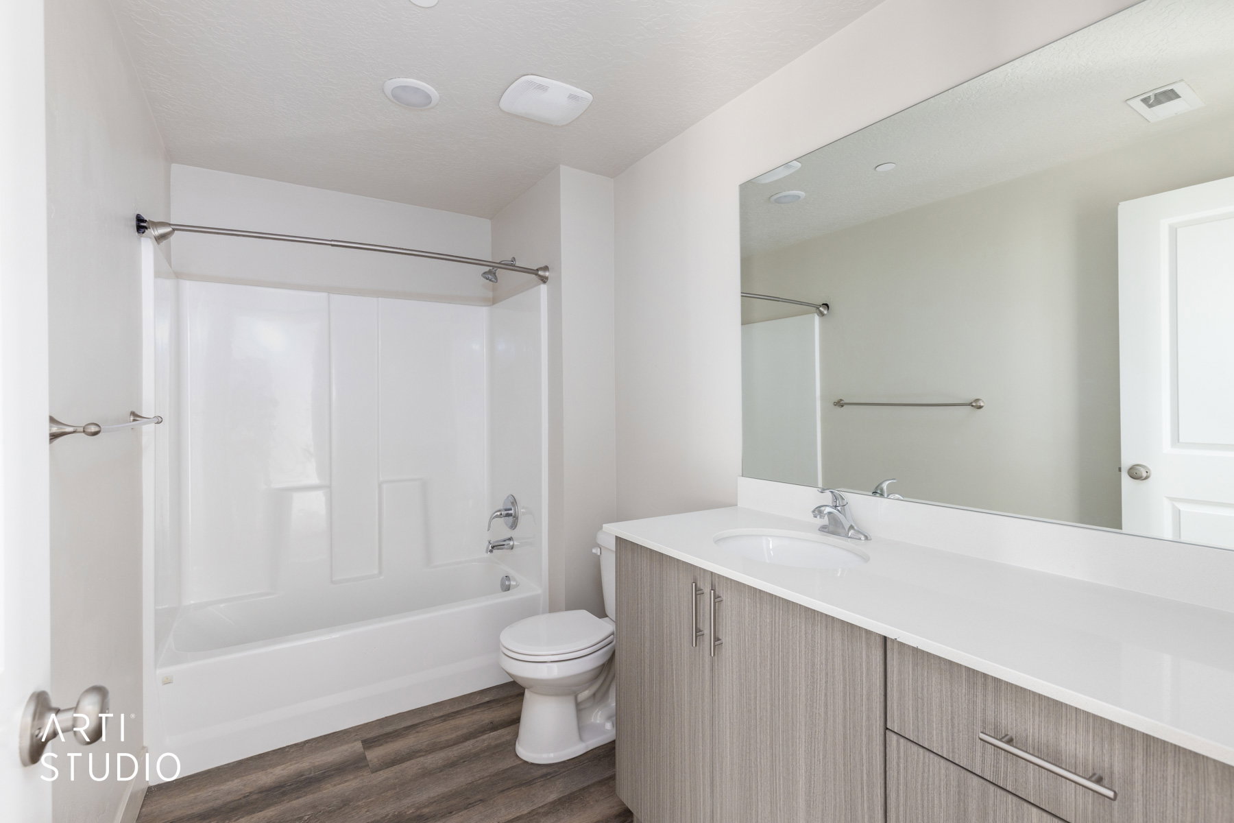 Full bathroom with bathtub / shower combination, vanity, dark wood finished floors, and a textured ceiling