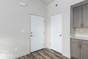 Entryway with wood finished floors and baseboards