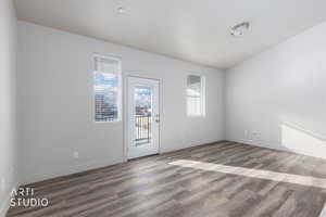 Empty room featuring wood finished floors and baseboards